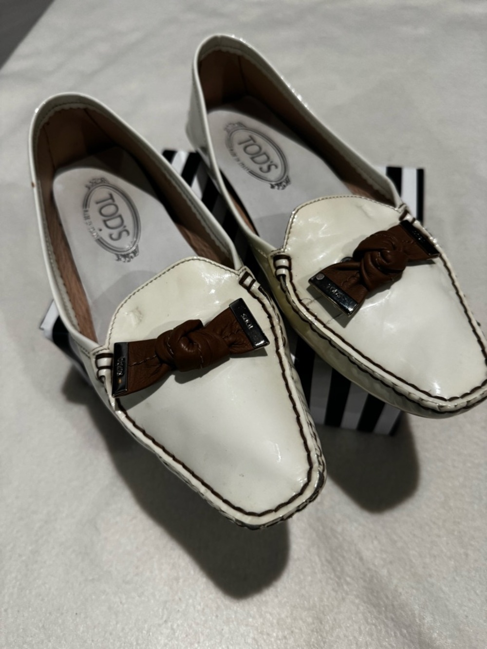 Tod's White Patent Loafers with Brown Knot Detail